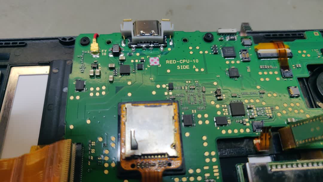 Picture of the top of a new
		3DS xl main board. The newly installed USB-C power connector is visible.