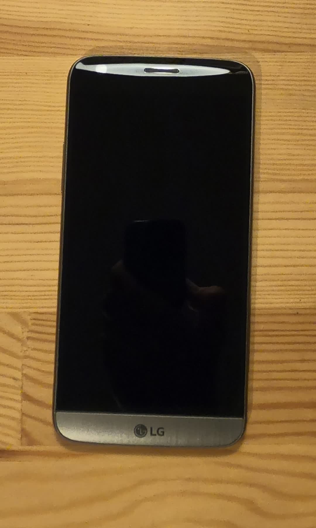Picture of an LG G5
		smartphone showing its front. The screen is off.