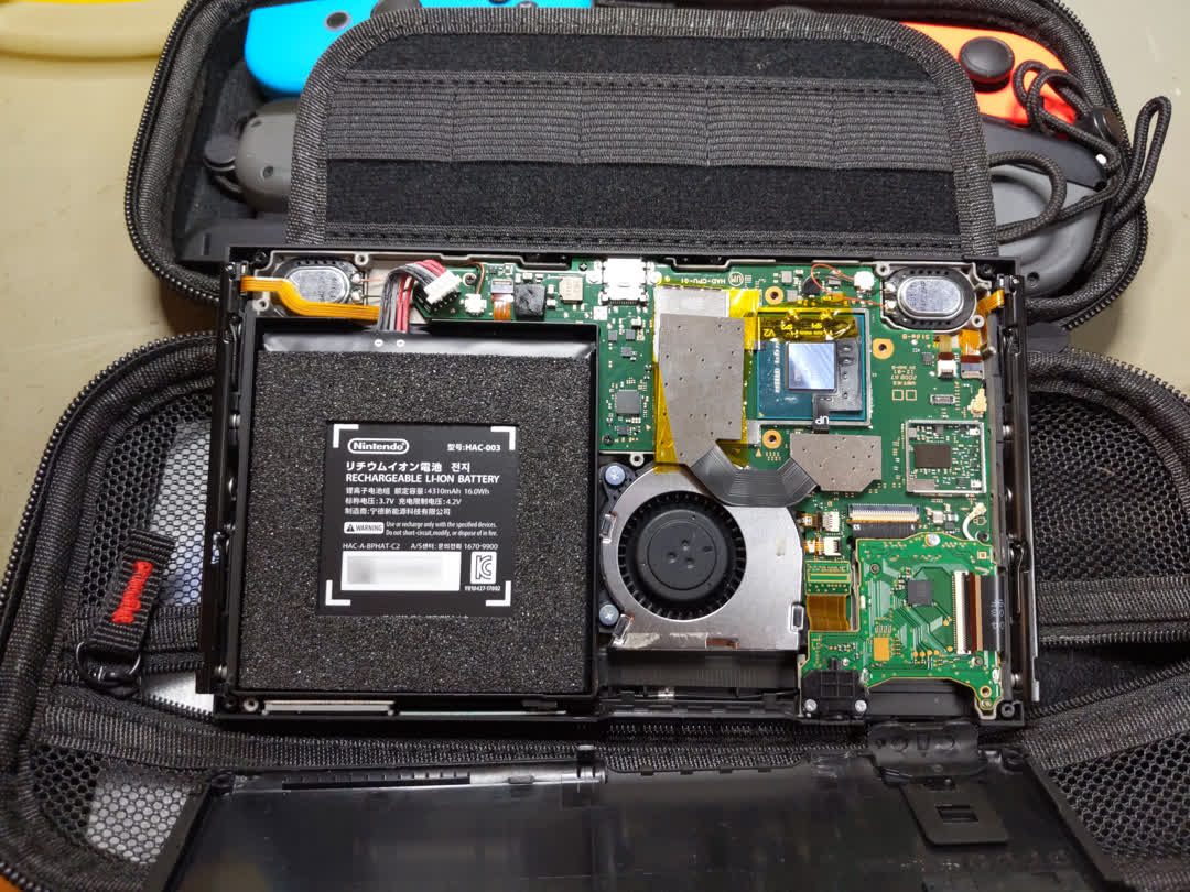Inside of a switch console. The
    internal heat spreader (IHS) is removed showing the bare SOC. 