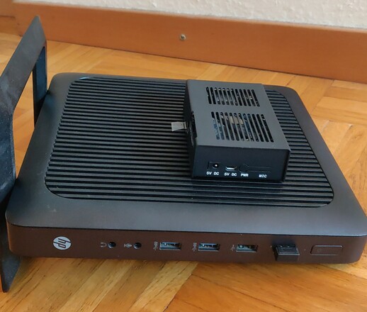 Picture of an HP t620 on
		its side with an Orange Pi 3 on top.